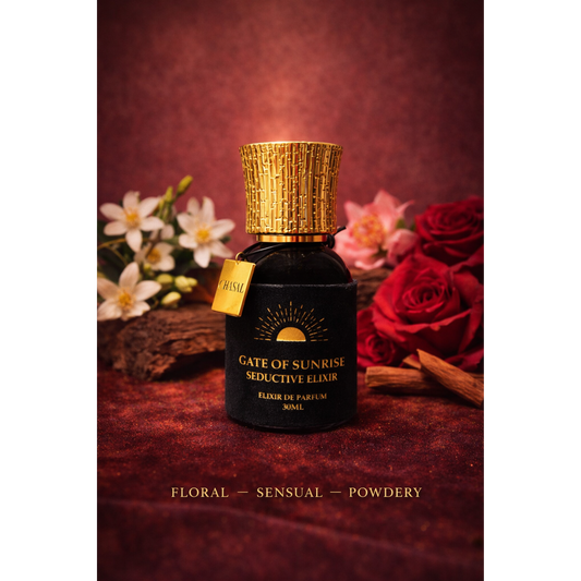 Schwarzer Parfumflakon des Seductive Elixiers umrahmt von roten Rosen, weißen Blüten und Zimtstangen – Sinnlicher Nischenduft von CHASAL